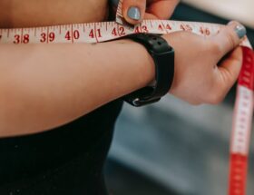 plus size woman measuring belly