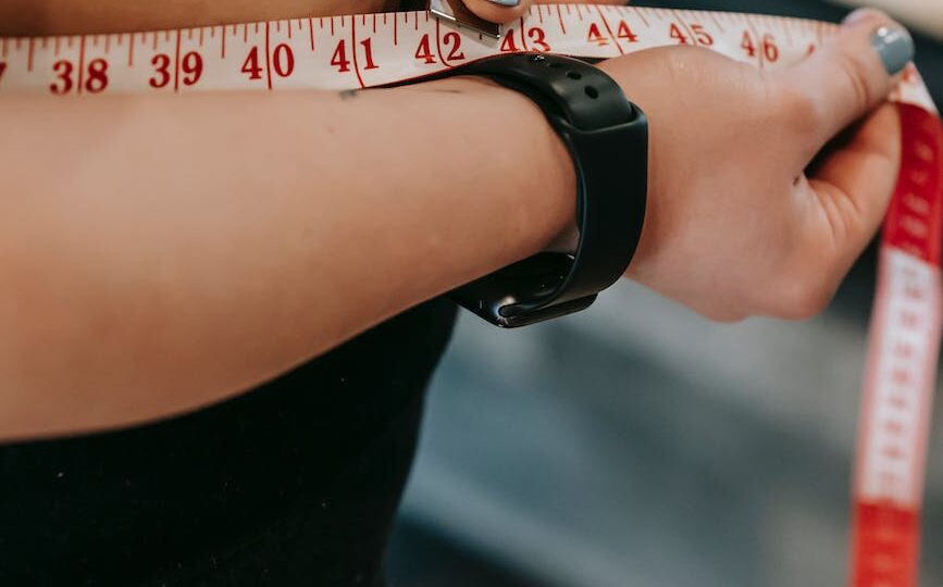 plus size woman measuring belly