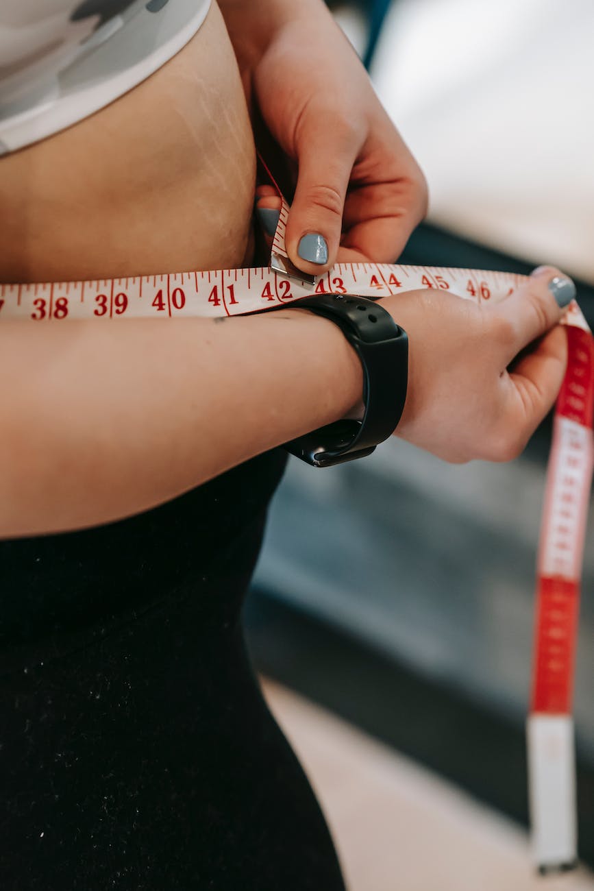 plus size woman measuring belly