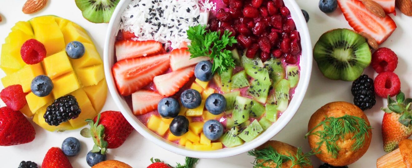 assorted sliced fruits in white ceramic bowl