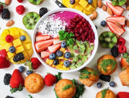 assorted sliced fruits in white ceramic bowl